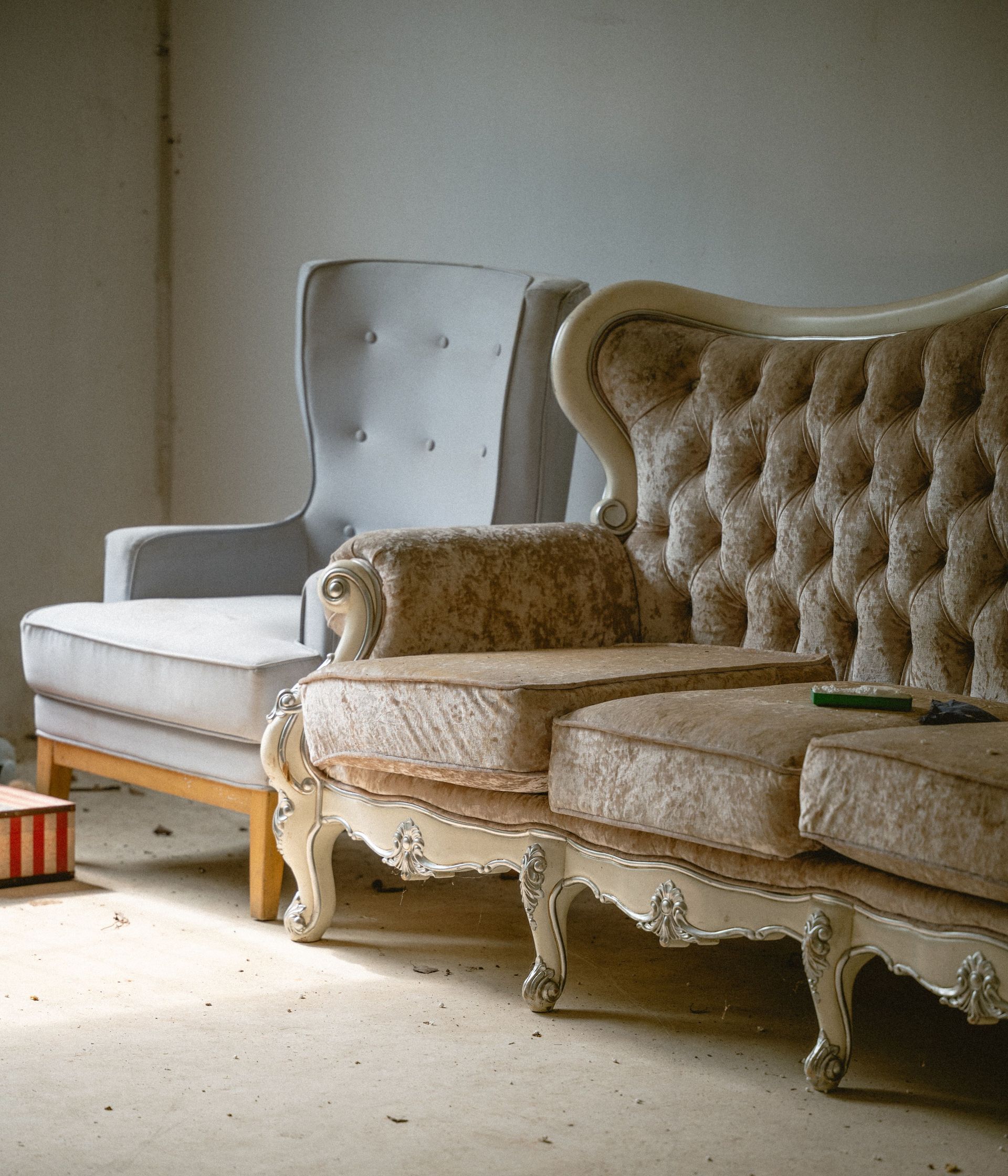 A vintage armchair and sofa in an old-fashioned living room, exuding nostalgia and elegance.